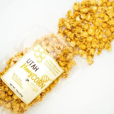 Bag of honey corn open and spilling out on white surface