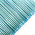 Close-up of blue straws on a white background