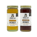 Two jars of honey from The Honey Jar on a white background