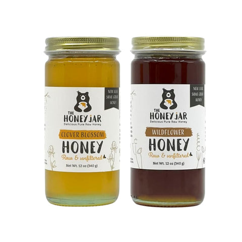 Two jars of honey from The Honey Jar on a white background