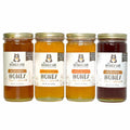 Four jars of honey with labels on a white background