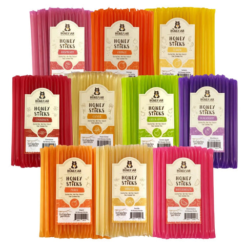 Assorted packages of Honey Sticks in various flavors on a white background