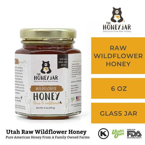 Jar of raw wildflower honey with 'The Honey Jar' branding on a white background