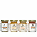 Four jars of Honey Jar honey on a white background