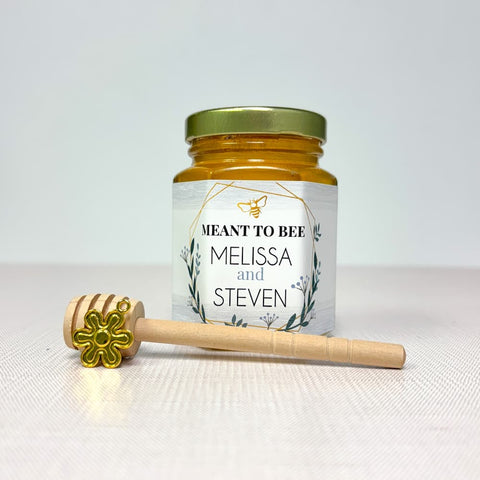 Jar of honey with a honey dipper on a white background