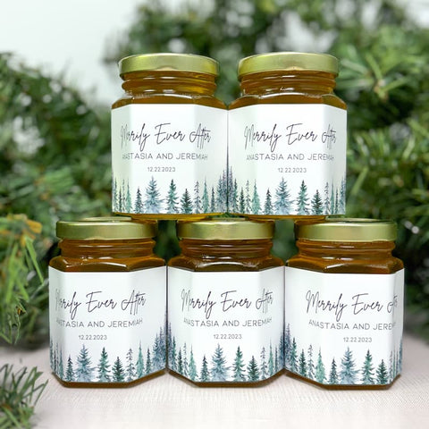 Hexagonal arrangement of honey jars with personalized labels against a blurred greenery background