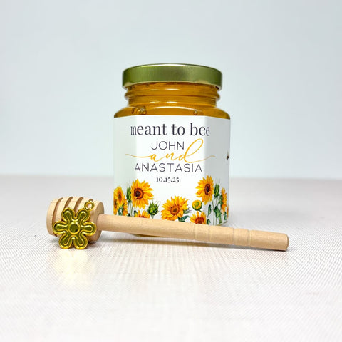 Honey jar with floral label and honey dipper on a white background