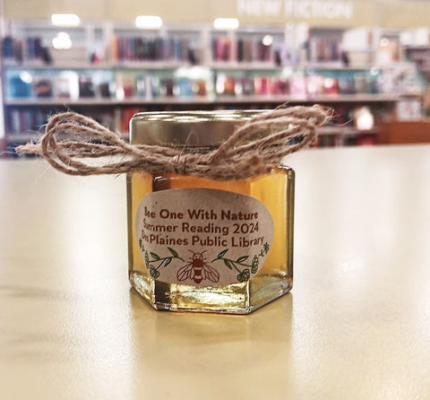 Jar of honey with a label on a table in a library setting