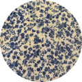 Round fabric swatch with blue floral pattern on a beige background