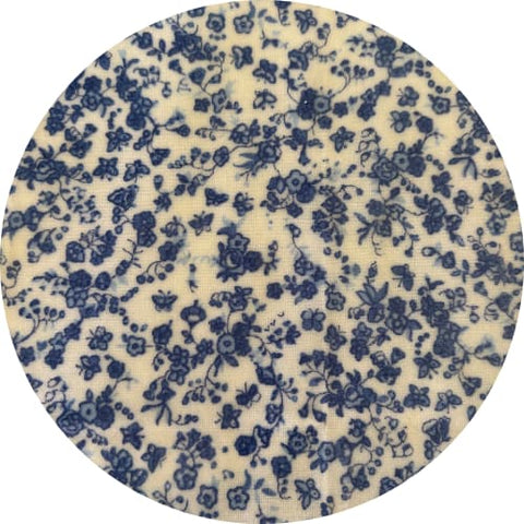Round fabric swatch with blue floral pattern on a beige background