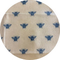 Round beige fabric patch with blue bee pattern