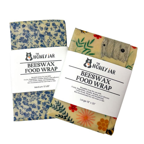 Two packages of Beeswax Food Wrap with floral and nature-themed designs on a white background.
