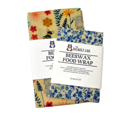 Set of two beeswax food wraps with floral designs on a white background
