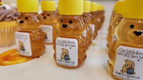 Honey bear bottles with personalized labels on a white surface