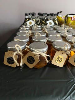 Jars of honey with labels on a table