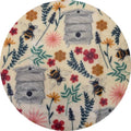 Round fabric sample with bee and flower pattern on a white background