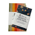 Two colorful beeswax food wraps with a white label on a white background