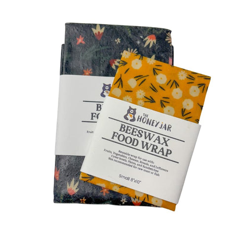 Two beeswax food wraps with floral designs on a white background
