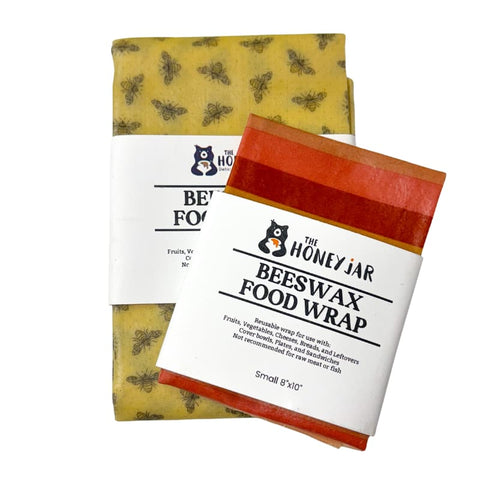 Two beeswax food wraps with stripe and bee patterns and 'The Honey Jar' branding on a white background