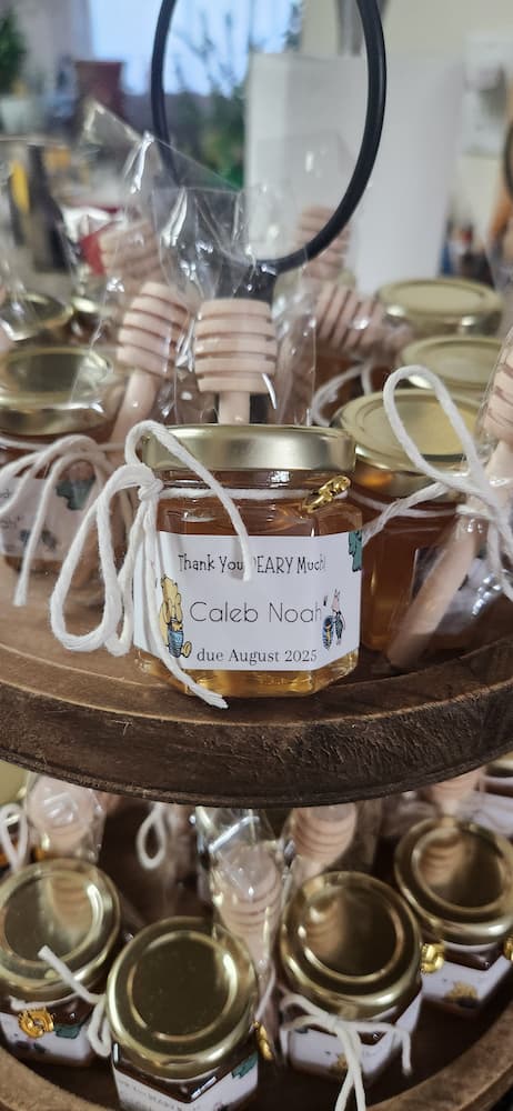 Jars of honey with labels on a wooden stand