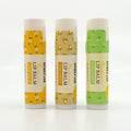 Three lip balms with different flavors on a white background
