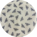 Round fabric swatch with bee pattern on a beige background
