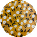 Round fabric swatch with white flowers on a yellow background