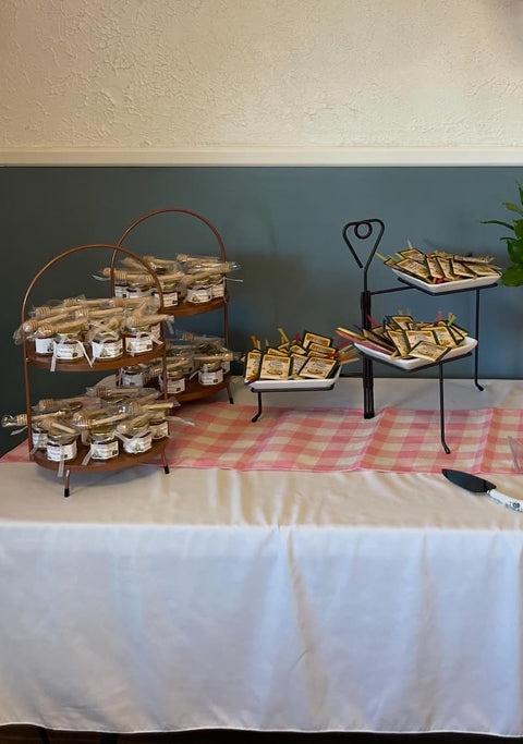 Table with food display on a checkered tablecloth against a plain wall.