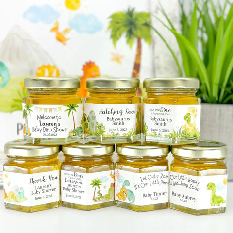 Jars with personalized labels for a baby shower against a blurred indoor background