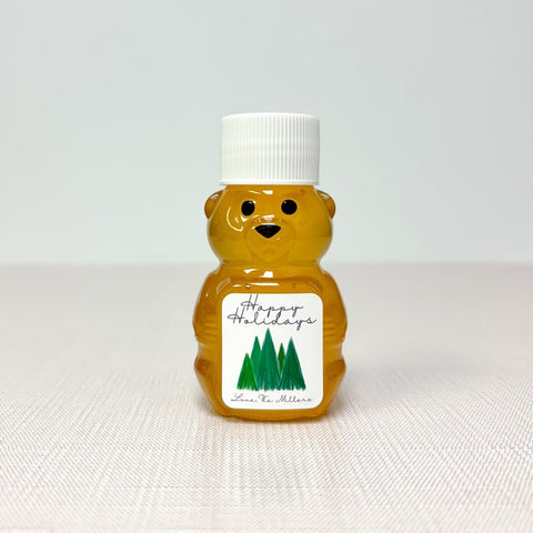 Honey bear bottle with a 'Happy Holidays' label on a white background