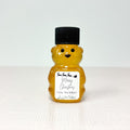 Honey bear with a black lid and Christmas label on a white background