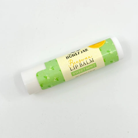 Green lip balm with a label on a white background