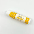 Vanilla lip balm with yellow and white packaging on a white background