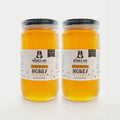 Two jars of clover blossom honey from The Honey Jar on a white background