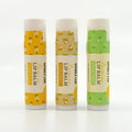 Three lip balm sticks with different flavors on a white background