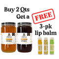 Two jars of honey with a free lip balm offer on a white background