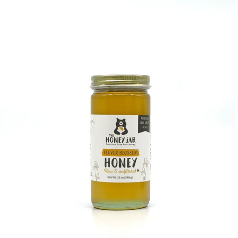 Jar of honey with a label on a white background