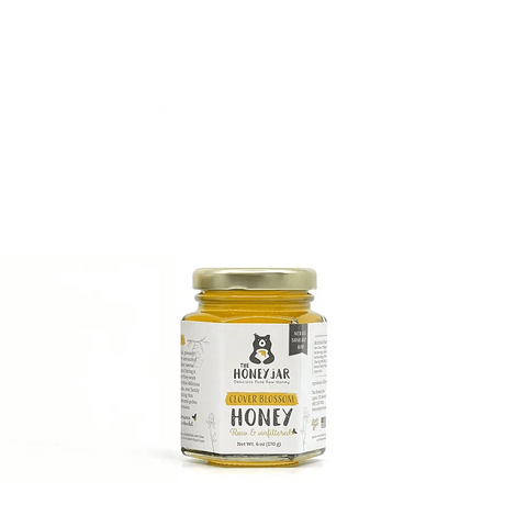 Jar of honey with a label on a white background