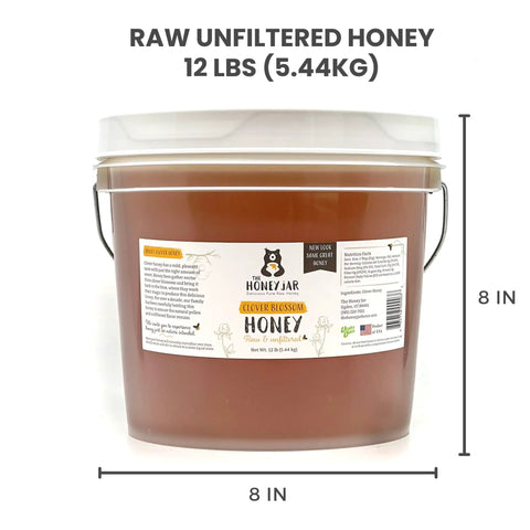 Bucket of raw unfiltered honey with label and dimensions on a white background
