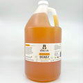 Gallon jug of honey with a label on a white background