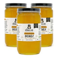 Three jars of honey with labels on a white background