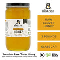 Jar of raw clover honey with 'The Honey Jar' branding on a white background