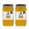 Two jars of 'Clover Blossom Honey' from 'The Honey Jar' on a white background