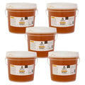 Five buckets of honey with labels on a white background