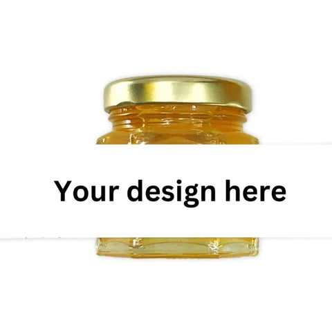 Small jar of honey with a gold lid and open blank label with 'your design here' wording on a white background