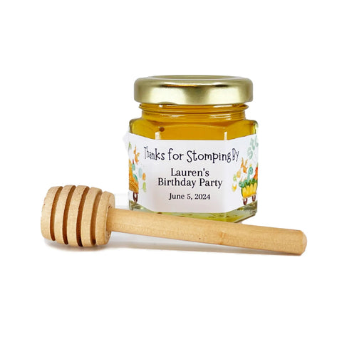 Jar of honey with a wooden dipper on a white background
