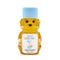 Honey bear bottle with blue cap and baby-themed label on a white background