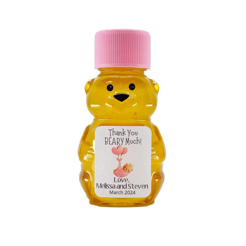 Bear-shaped honey bottle with pink cap and personalized label on a white background