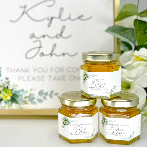 Three jars of honey with personalized labels on a decorative background