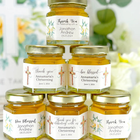 Stack of honey jars with personalized labels against a floral background